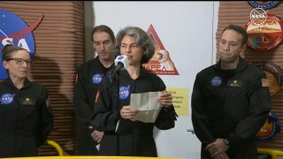 Anca Selariu, a crew member of the first CHAPEA mission, speaks in front of other members, from left to right, Kelly Haston, Ross Brockwell, and Nathan Jones