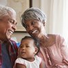 Purchased - Grandparents Sitting On Sofa With Baby Granddaughter At Home