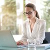 Woman sitting at a desk working on her computer