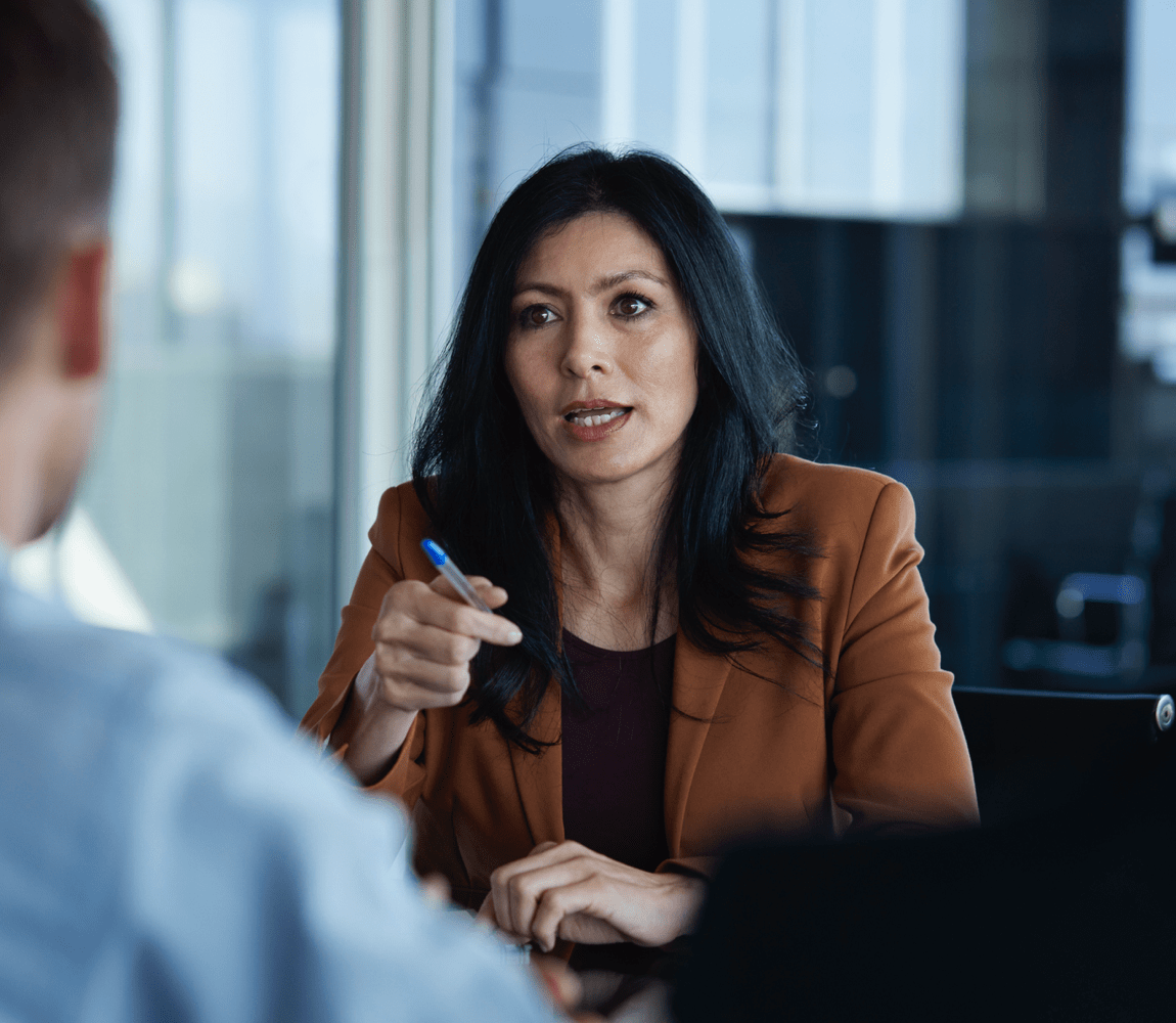 Woman speaking to man in office setting