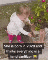 a little girl is standing in front of a christmas tree and a sign that says she is born in 2020