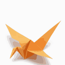 an orange origami bird with its wings outstretched