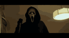 a person wearing a scream mask and holding a knife