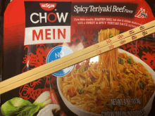 a package of spicy teriyaki beef chow mein noodles with chopsticks