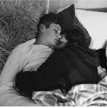 a black and white photo of a man and woman sleeping