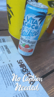 a can of vita coco spiked strawberry daiquiri sits on a wooden table