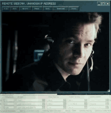 a computer screen shows a man wearing headphones and the words remote webcam unknown ip address at the top