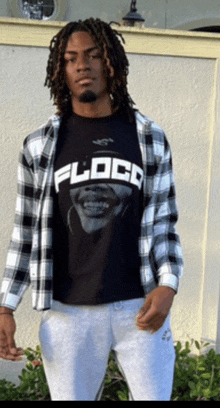 a man wearing a black t-shirt with the word floco on it