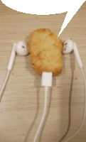 a fried chicken nugget is plugged into a pair of ear buds