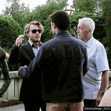 johnny depp gifs shows a group of men standing outside