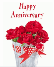 a bouquet of red roses in a bucket with the words happy anniversary above it