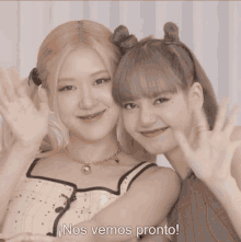 two girls are posing for a picture and the words nos vemos pronto are written below them