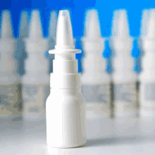 a row of nasal spray bottles are lined up in a row