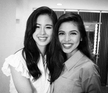 two women are posing for a picture together and smiling for the camera