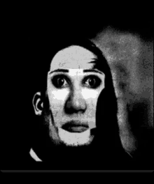 a black and white photo of a person with a mask on their face .