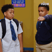 two boys are standing in front of a sign that says " is the sound you hear when you listen "