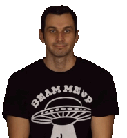 a man wearing a beam me up t-shirt looks at the camera