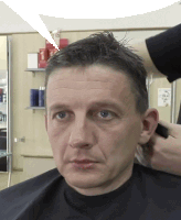 a man getting his hair cut in a salon