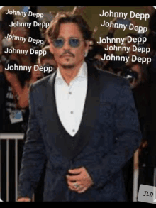 a man in a suit and sunglasses with the name johnny depp written on the bottom