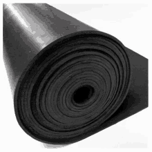 a roll of black rubber with a hole in the middle on a white background