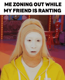 a woman wearing a yellow hoodie has a white mask on her face