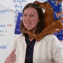 a woman with a kangaroo balloon on her head stands in front of a white board that says bogan dag