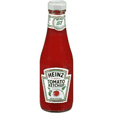 a bottle of heinz tomato ketchup is sitting on a table .