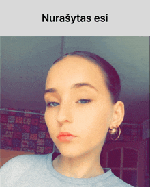 a woman 's face is shown with the words nurasytas esi above it