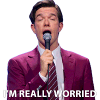 a man in a purple suit is singing into a microphone with the words " i 'm really worried " behind him