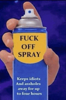 a person holding a spray can that says fuck off spray