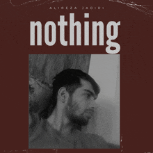 a man leaning against a wall with the word nothing behind him