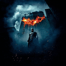 a poster of batman standing in front of a building on fire