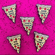 five slices of pizza with she they them written on them on a pink surface