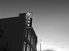 a black and white photo of a building with a neon sign that says ccc