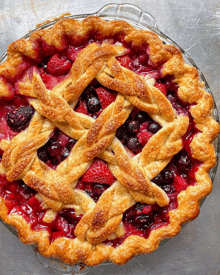 a pie with a lattice crust and berries on it