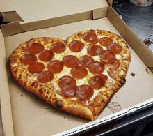 a heart shaped pepperoni pizza in a pizza box