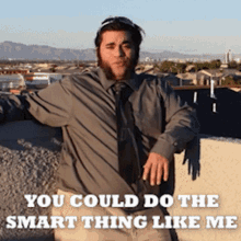 a man in a grey shirt and tie is standing on a ledge with a caption that says you could do the smart thing