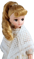 a doll with blonde hair is wearing a white lace scarf around her neck