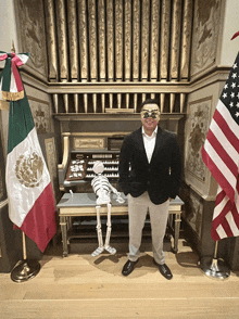 a man wearing a mask stands in front of a mexican and american flag