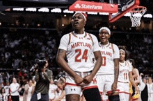 a maryland basketball player wearing number 24 celebrates