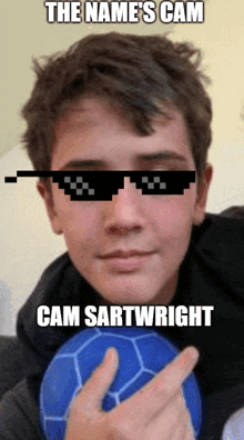 a young man wearing sunglasses and holding a blue soccer ball with the name cam sartwright written below him