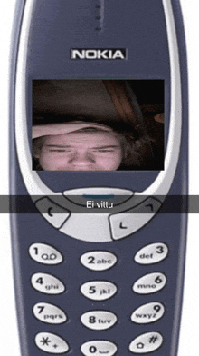 a blue nokia phone with a picture of a man on the screen