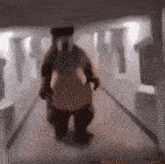 a blurry picture of a person in a costume walking down a hallway .