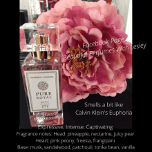 a bottle of pure royal perfume next to a flower