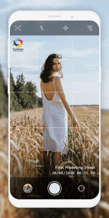 a woman in a white dress is standing in a field of wheat