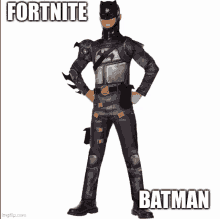 a man in a batman costume is standing with his hands in his pockets ..