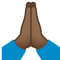 a person 's hands are folded in prayer with a blue shirt on