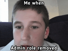 a young boy sitting on a couch with a meme that says me when admin role removed