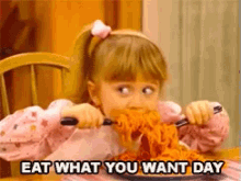 a little girl is eating spaghetti with the words eat what you want day written below her