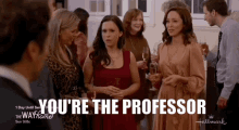 a group of people standing in a room with the words you 're the professor